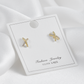 Aretes baño de oro en x con circonitas IM4 - A34